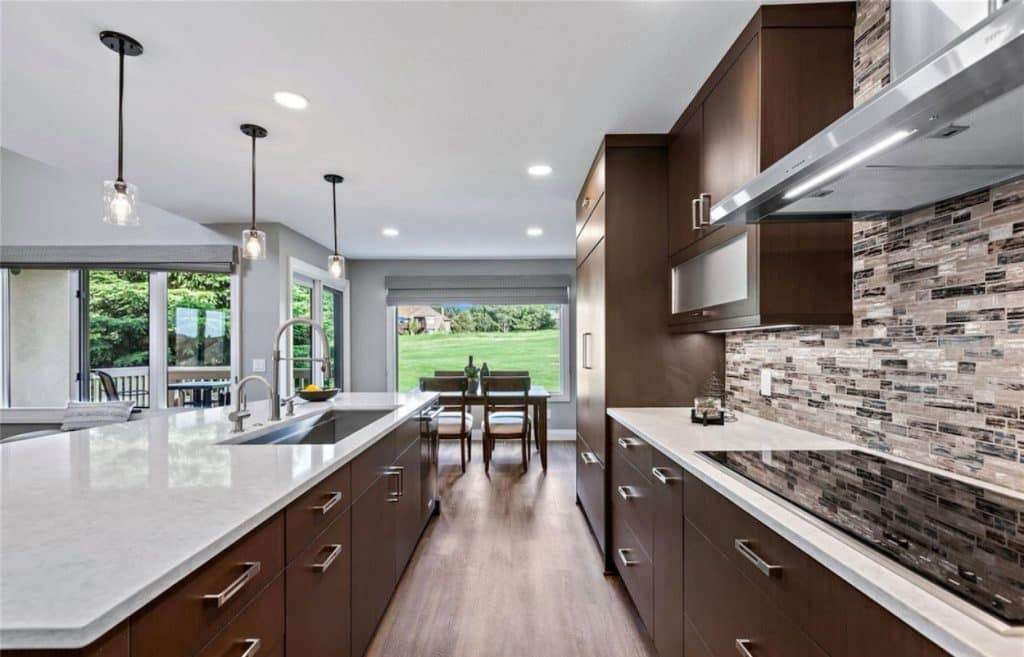 modern renovated kitchen with white countertop and brown cabinets