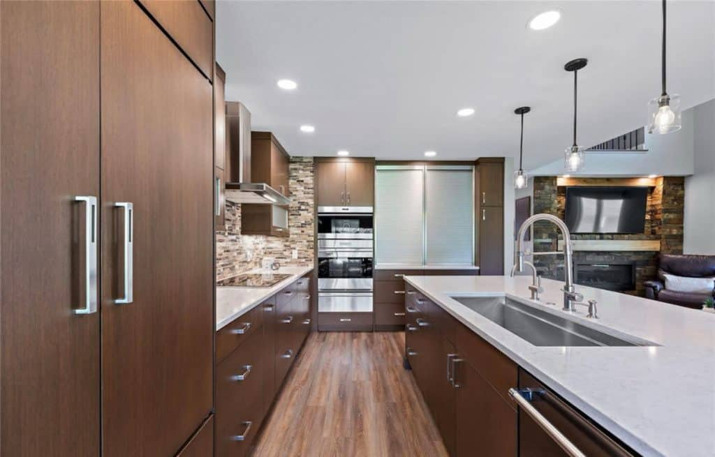 modern renovated kitchen with white countertop and brown cabinets